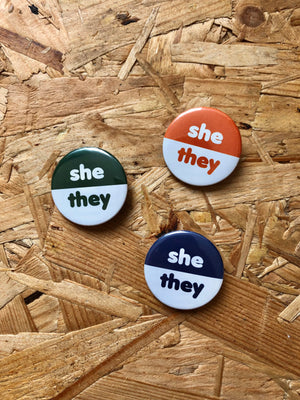 
            
                Load image into Gallery viewer, She/They Two-Tone Pronoun Badges 32mm
            
        